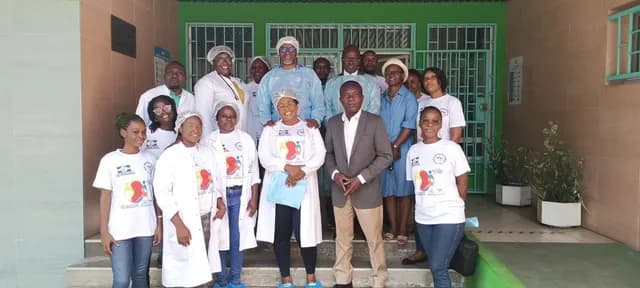 Team in T-shirts and white coats at the entrance of the National Haemodialysis Centre