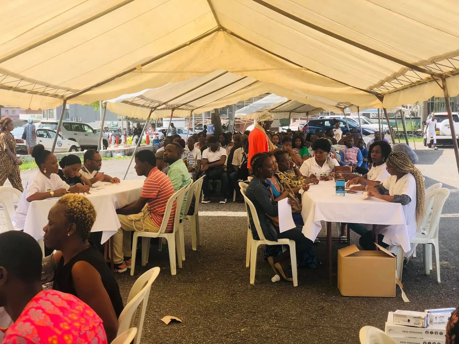 Under the large tent, visitors wait for their free screening with the medical teams