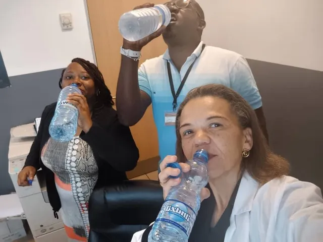 Three team members drink water for the “I stop to drink water” challenge