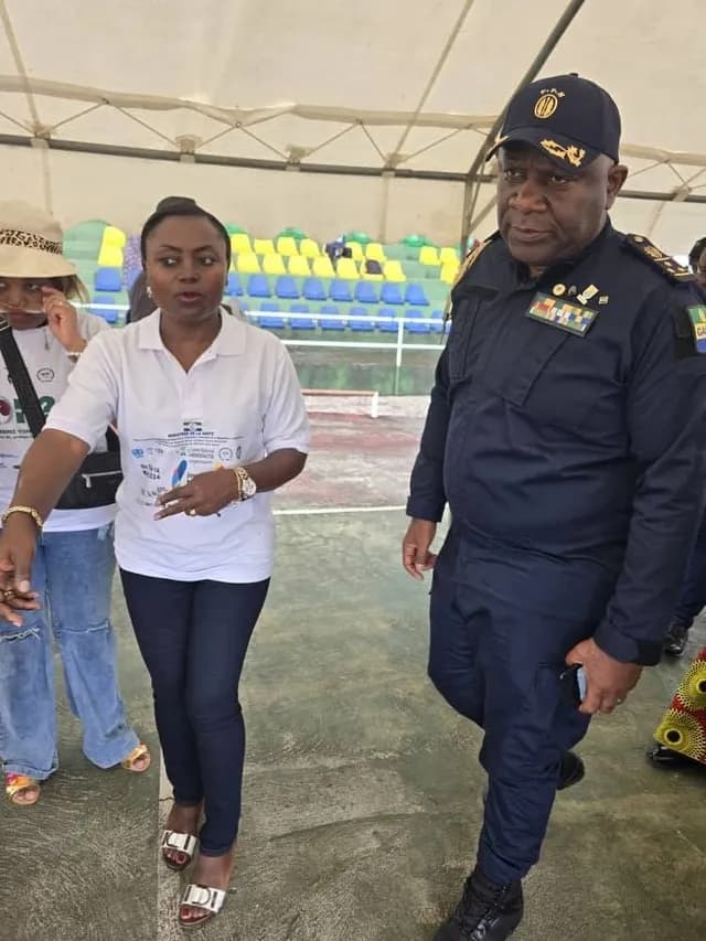 A volunteer and an officer on a sports ground during World Kidney Day 2025