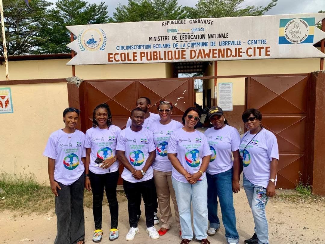 Screening team in T-shirts in front of the Awendjé public school in Libreville